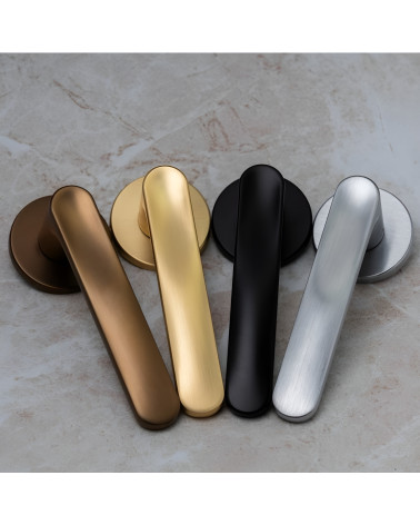 Maniglia per porta RITA maniglia design presentate su una superficie grigia