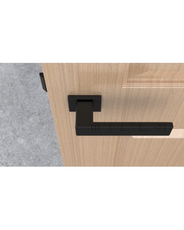 Maniglia per porta nera PINA design vista dall'alto montata su una porta