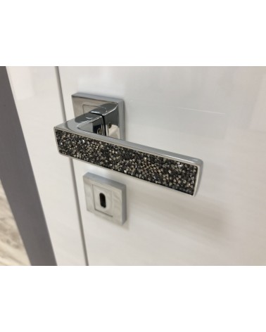 Maniglia per porta cromo lucido GLAMOUR ferramenta design vista inclinata montata su una porta