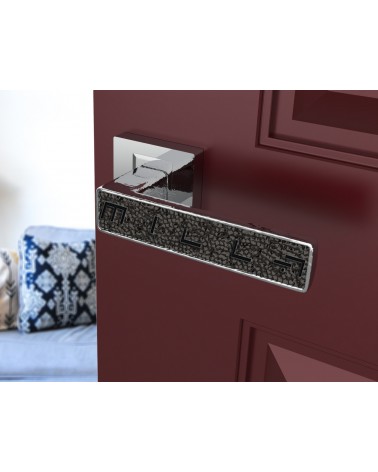 Maniglia per porta cromo lucido GLAMOUR ferramenta design vista inclinata montata su una porta socchiusa