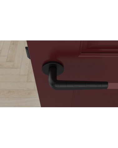 Maniglia per porta su placca rotonda INULLA maniglia design vista dall'alto montata su una porta