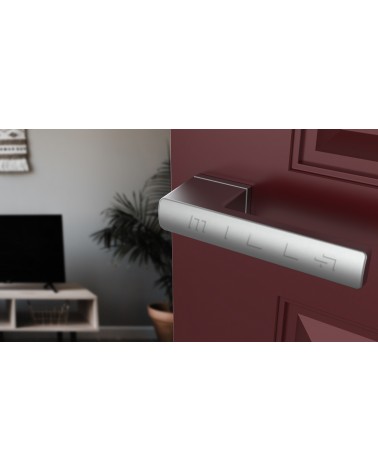 Maniglia per porta BRISA maniglia design colore 2 montata su una porta socchiusa
