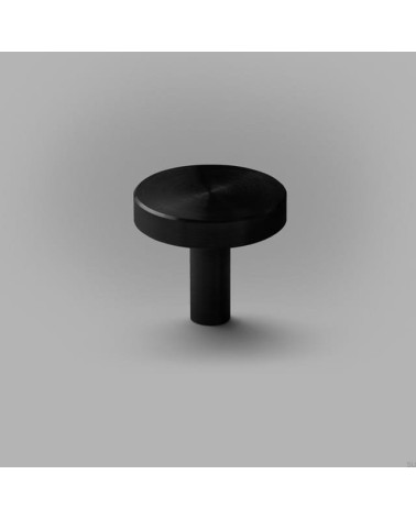 Pomello per mobile nero NENA M maniglia design posata su una superficie piana