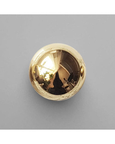 Pomello per mobile in oro lucido ODETE maniglia design posata su sfondo grigio