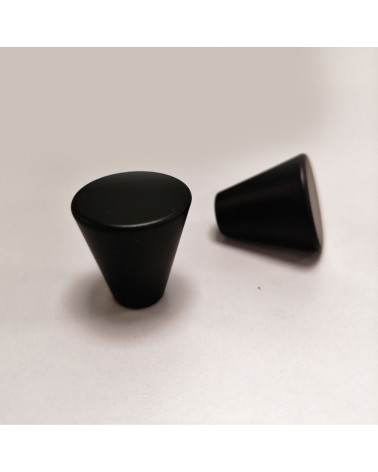 Pomello per mobile nero AMBIENT maniglia design posata su uno sfondo