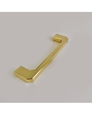 Maniglia per mobile oro lucido CAMPANA maniglia design posata su una superficie grigia