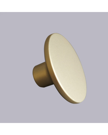 Pomolo per mobile oro opaco ASTRO maniglia design su sfondo grigio