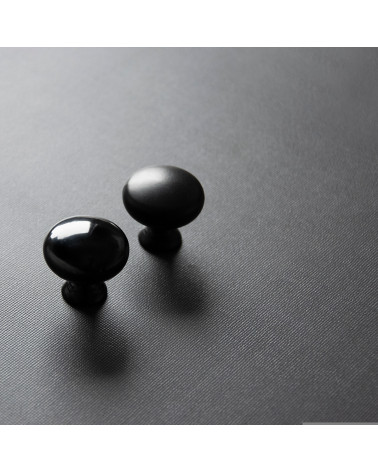 Pomello per mobile TORONTO maniglia design posizionati in diagonale su una superficie scura