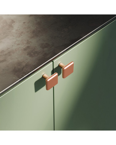 Pomello per mobile rame NOX maniglia design fissato su un mobile