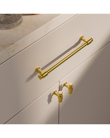 Pomello per mobile GALIUM oro lucido maniglia design vista dall'alto inclinata montato su un mobile bianco
