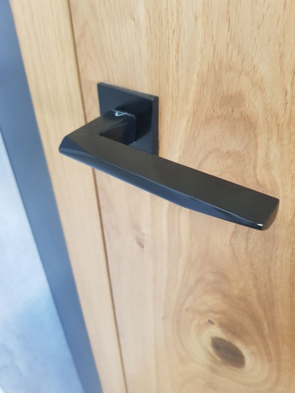 maniglia nera design su una porta in legno